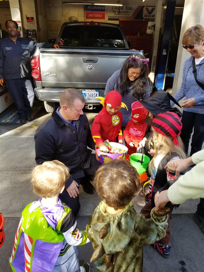 Handing out Halloween candy to the local preschoolers, outside of Paul's Automotive.